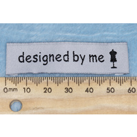 Tag,white, black embroidered wording "designed by me " with dress maker dummy symbol