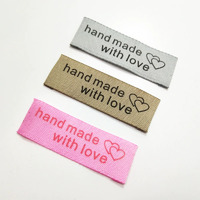 Tag, bronze, black embroidered wording "hand made with love " with double heart symbol