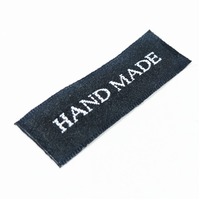 Tag,black, silver embroidered wording "Handmade "