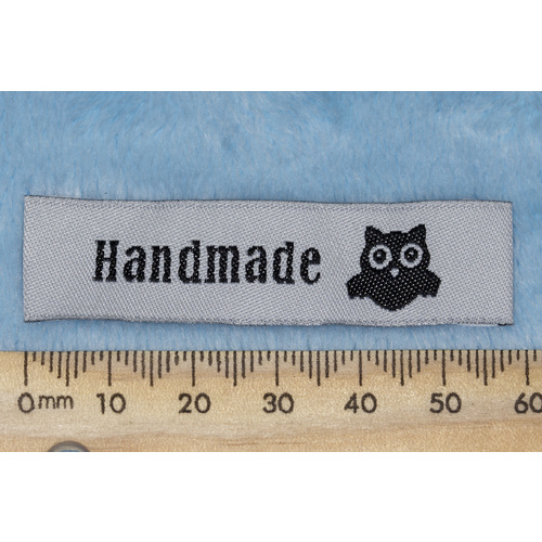 Tag, white, black embroidered wording "Handmade" with Owl symbol