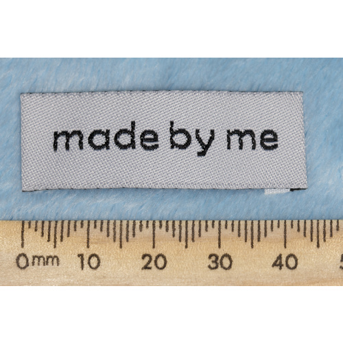 Tag, white, black embroidered wording "made by me" 