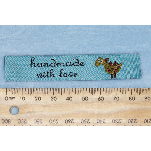 Tag,blue with black embroidered  wording "handmade with love " with dinosaur symbol