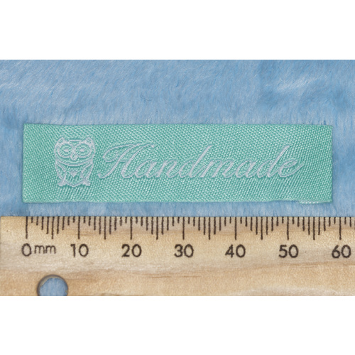 Tag, mint with white embroidered  wording "Handmade" with Owl symbol