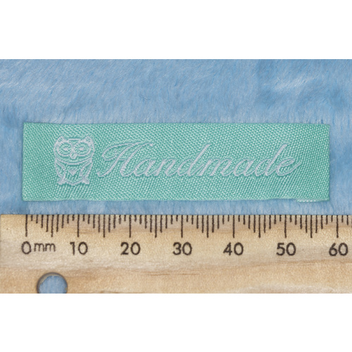 Tag, mint with white embroidered  wording "Handmade" with Owl symbol